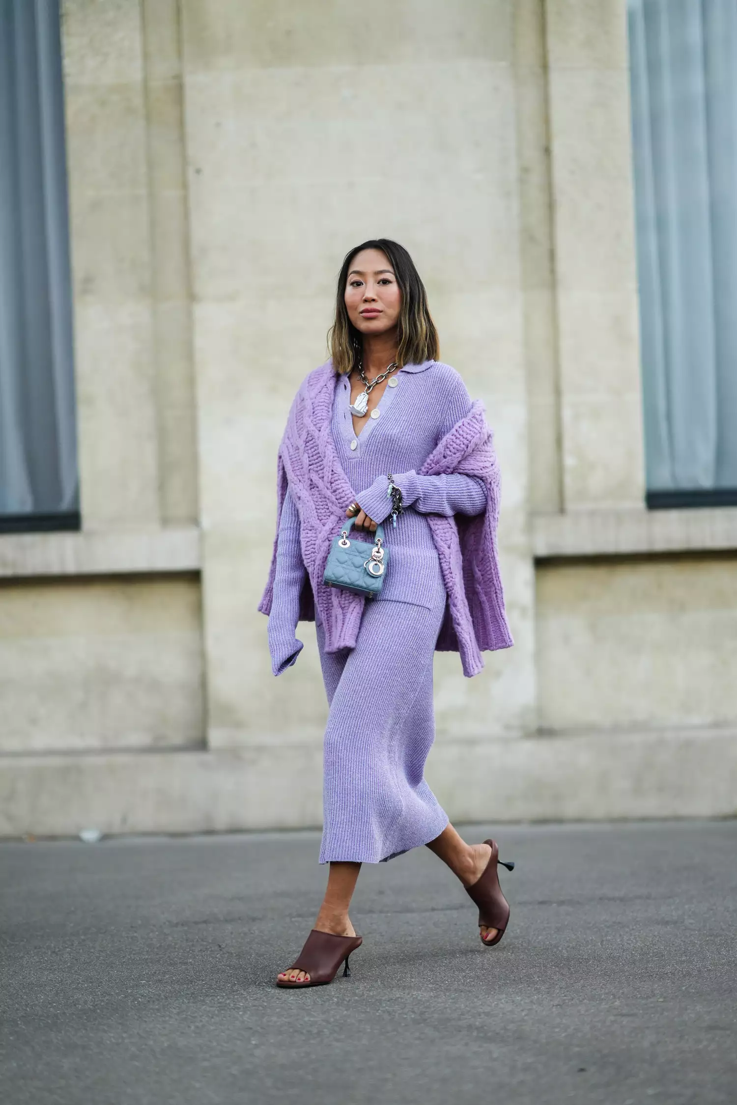 woman wearing brown open-toe mules and a purple sweater dress